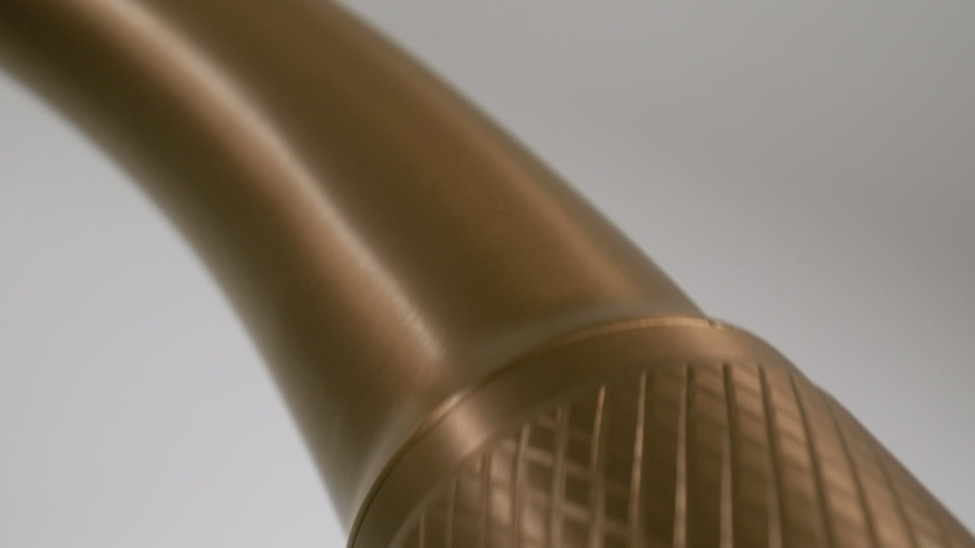 Cinematic video of a Titan curved arc mixer tap in brass, featuring close-up angles that highlight the elegance and design of the brass tapware.